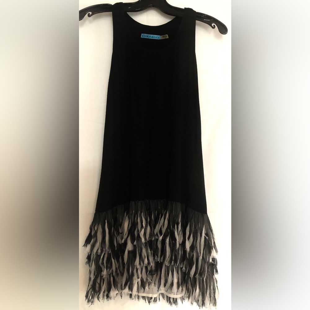 Alice+ Olivia black Jersey dress. The fabric fringe hits at your knee.